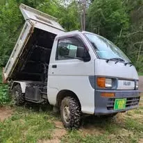 White Japanese mini truck with hydraulic dump bed raised