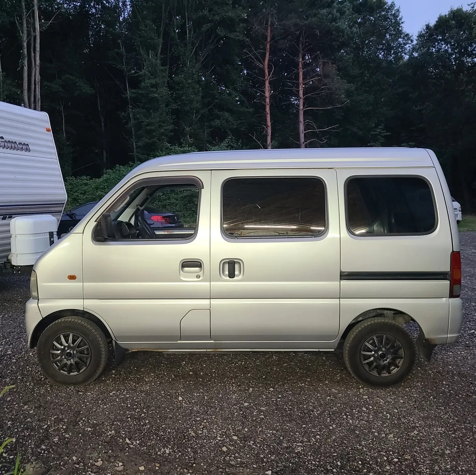 Silver 4x4 Japanese mini van, side view